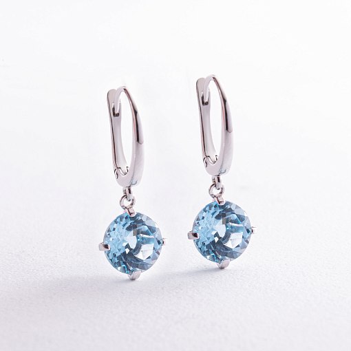 Золотые серьги "Влечение" с голубым топазом с08003