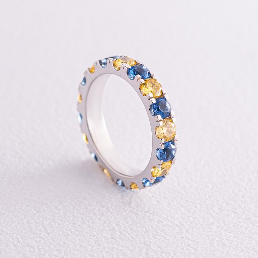 Каблучка з доріжкою блакитного та жовтого каміння (біле золото) к07108